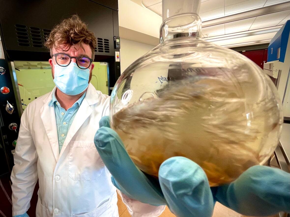 Dr. Vincent Ziffle, assistant professor of chemistry at First Nations University of Canada, works with plant specimens in the Regina campus' organic chemistry laboratory.  (Richard Agecoutay/CBC - image credit)