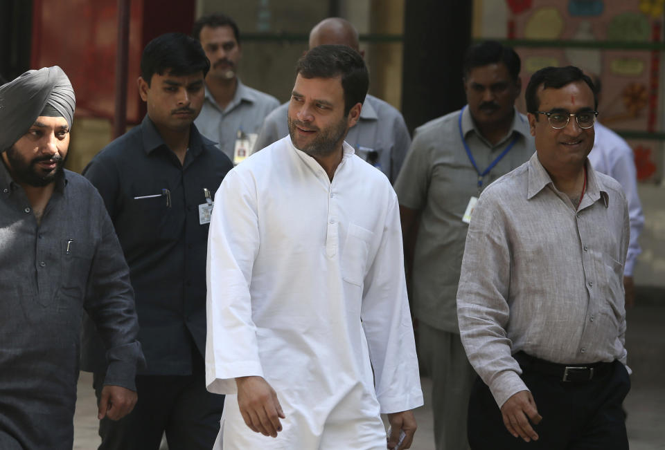 India’s ruling Congress party Vice President Rahul Gandhi, center, returns after casting his vote during parliamentary elections in New Delhi, India, Thursday, April 10, 2014. Millions of people are voting in the third phase of the elections Thursday, covering parts of 11 of India's 28 states. The multiphase voting across the country runs until May 12, with results for the 543-seat lower house of parliament announced May 16. (AP Photo /Manish Swarup)