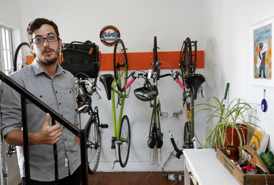 In this Thursday, March, 27, 2014 photo, Marc Caswell, who recently moved from San Francisco to Los Angeles, poses for a photo in his newly rented apartment in the Los Feliz district of Los Angeles. Rising rents in San Francisco compelled Marc Caswell to move to Los Angeles in September. (AP Photo/Damian Dovarganes)