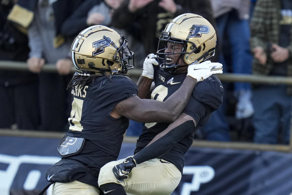 Purdue wide receiver TJ Sheffield, RIGHT, celebrates a touchdown against Minnesota with wide receiver Deion Burks (4) during the first half of an NCAA college football game in West Lafayette, Ind., Saturday, Nov. 11, 2023. (AP Photo/Michael Conroy)