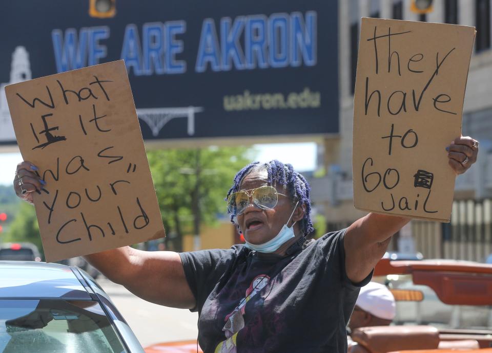 Gloria Beasley stands with protesters Saturday on South High Street in front of the Harold K. Stubbs Justice Center in Akron.