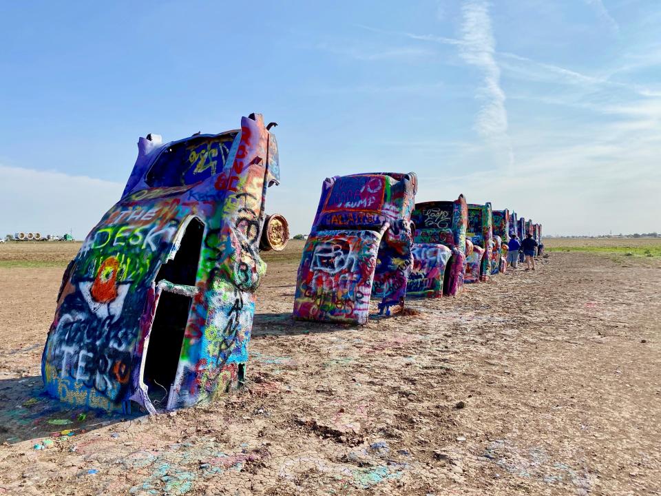 Spray painted Cadillac cars on display in the desert.