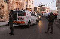 Israeli security forces and ambulances gather at the site of a stabbing attack near the shared religious site known to Jews as the Cave of the Patriarchs and to Muslims as the Ibrahimi Mosque, in the West Bank town of Hebron, on February 14, 2016