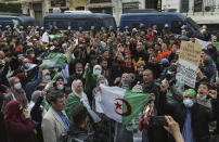 People demonstrate with Algerian flags for a second time this week in Algiers, Algeria, Feb. 26, 2021. Algerians turned out on Friday in the streets of the capital and scattered cities around their North African country to demonstrate in the pro-democracy movement, four days after tens of thousands of marchers marked Hirak's second anniversary. (AP Photo/Anis Belghoul)