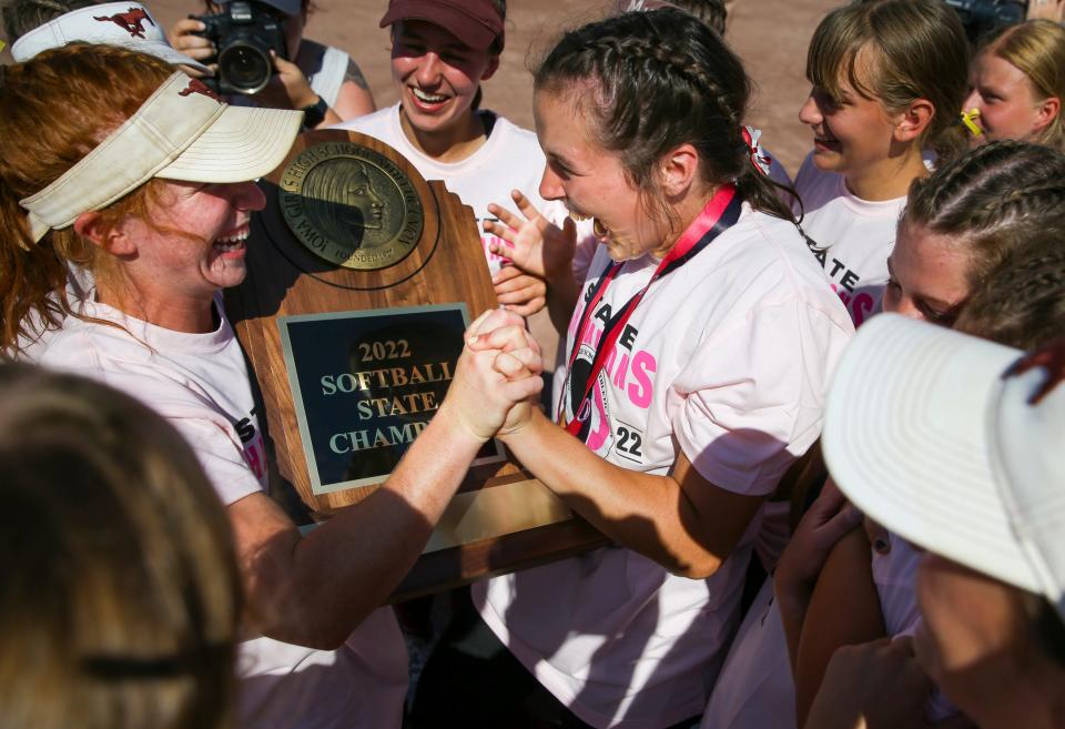Mount Vernon players celebrate with the trophy after beating Assumption during the Class 3A softball state championship on Friday at the Harlan Rogers Sports Complex in Fort Dodge.