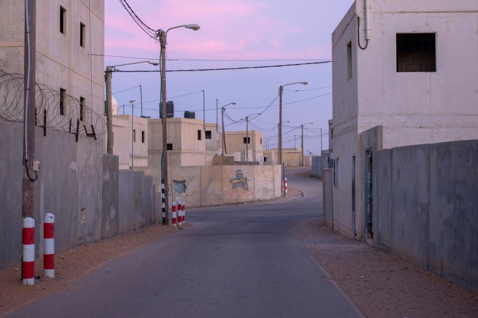 A graffiti shows a figure of a militant at the IDF Urban Warfare Training Center, designed as a mock Palestinian village at the Zeelim army base, southern Israel, Nov. 9, 2021.