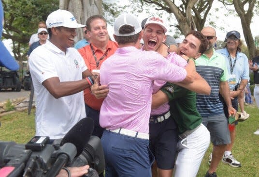 Aaron Jarvis of the Cayman Islands is mobbed by friends and family after winning the Latin American Amateur on Sunday at the Casa de Campo Resort in the Dominican Republic.