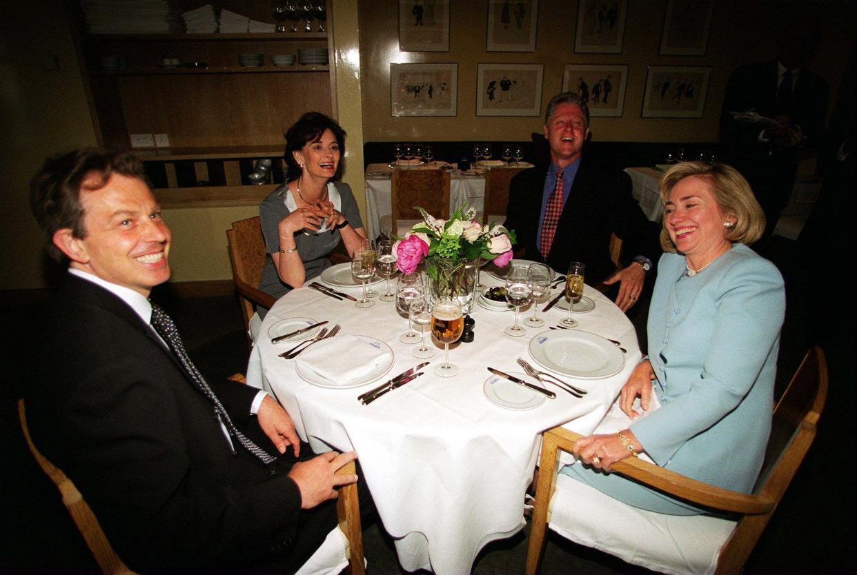 Embargoed to 0001 Tuesday July 20 File photo dated 29/05/1997 of Bill Clinton and his wife Hillary with Tony Blair (left) and his wife Cherie (2nd left) having dinner at Le Pont de la Tour Restaurant in London. Issue date: Tuesday July 20, 2021.