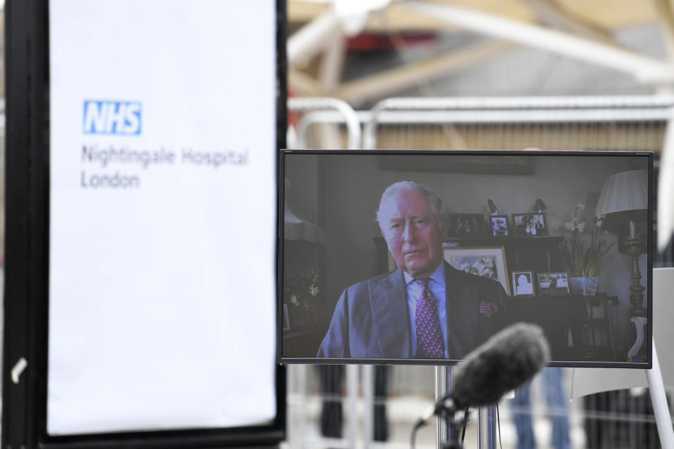 A view of Britain's Prince Charles projected on a screen as he delivers a video message from his residence in Scotland, during opening of the NHS Nightingale Hospital at the ExCel centre in London, Friday April 3, 2020. The ExCel centre has been converted into a 4000 bed temporary hospital NHS Nightingale amid the growing coronavirus outbreak. (Stefan Rousseau/Pool Photo via AP)