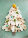 <p>The perfect use for mittens that have lost their matches: A triangular wall display that's right at home in a mudroom or other "bundle up" zone. Pin pom-pom ornaments in pastel shades to the "branches."</p><p><a class="link " href="https://go.redirectingat.com?id=74968X1596630&url=https%3A%2F%2Fwww.etsy.com%2Flisting%2F644623040%2Fpom-pom-ornament&sref=https%3A%2F%2Fwww.countryliving.com%2Fhome-design%2Fdecorating-ideas%2Fg28872053%2Falternative-christmas-trees%2F" rel="nofollow noopener" target="_blank" data-ylk="slk:SHOP POM-POM ORNAMENTS;elm:context_link;itc:0;sec:content-canvas">SHOP POM-POM ORNAMENTS</a></p>