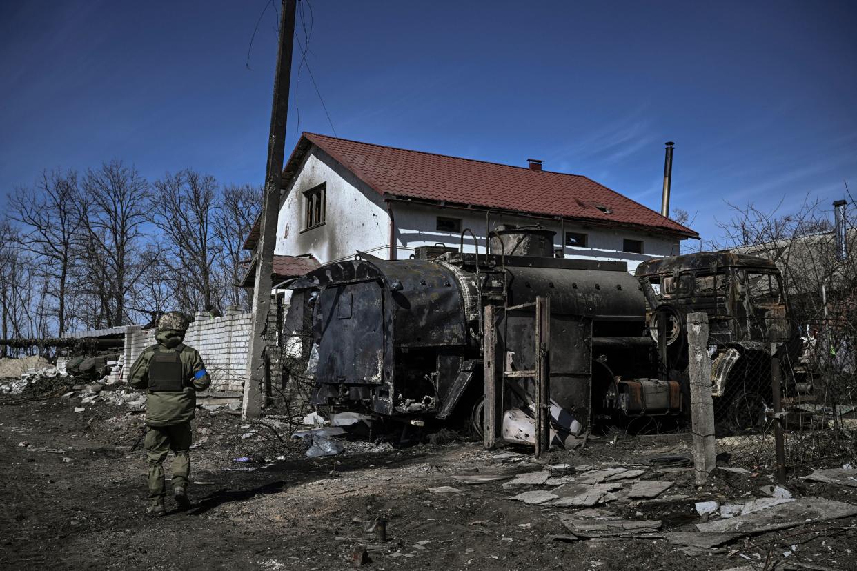 EDITORS NOTE: Graphic content / An Ukranian serviceman walks past a destroyed Russian vehicle in the village of Mala Rogan, east of Kharkiv, after the Ukranian troops retaking the village on March 28, 2022. (Photo by Aris Messinis / AFP) (Photo by ARIS MESSINIS/AFP via Getty Images)