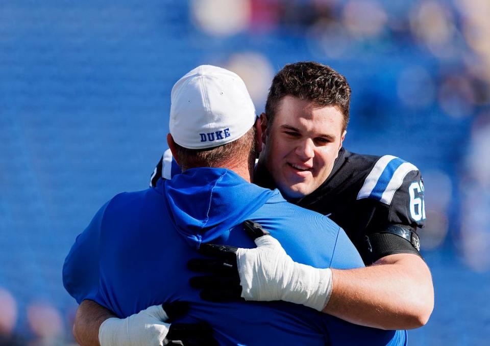 Duke’s Graham Barton hugs head coach Mike Elko during a Senior Day ceremony prior to the Blue Devils’ game against Pittsburgh on Saturday, Nov. 25, 2023, at Wallace Wade Stadium in Durham, N.C.