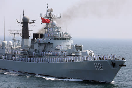 FILE PHOTO: Chinese servicemen gesture from the deck of a naval vessel, during the closing ceremony of the Pakistan Navy’s Multinational Exercise AMAN-17, in the North Arabian Sea, Pakistan, February 14, 2017. REUTERS/Akhtar Soomro/File Photo