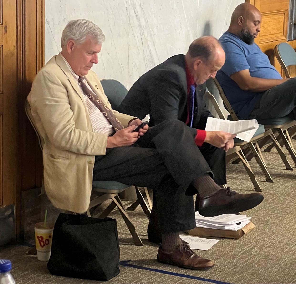Former lawmaker Tom Brinkman and his attorney Curt Hartman prepare for a hearing before Cincinnati City Council. Brinkman, with Hartman as his attorney, won a case against the Cincinnati Southern Raiway Board that alleged the board met in secret to hash out to the deal to potentially sell the railroad