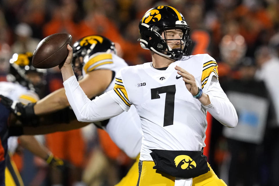 Iowa quarterback Spencer Petras passes during the first half of an NCAA college football game against the Illinois Saturday, Oct. 8, 2022, in Champaign, Ill. (AP Photo/Charles Rex Arbogast)