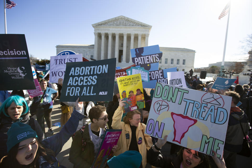 Abortion rights demonstrators along with Anti-abortion demonstrators rally outside of the U.S. Supreme Court in Washington, Wednesday, March 4, 2020. The Supreme Court is taking up the first major abortion case of the Trump era Wednesday, an election-year look at a Louisiana dispute that could reveal how willing the more conservative court is to roll back abortion rights. (AP Photo/Jose Luis Magana)