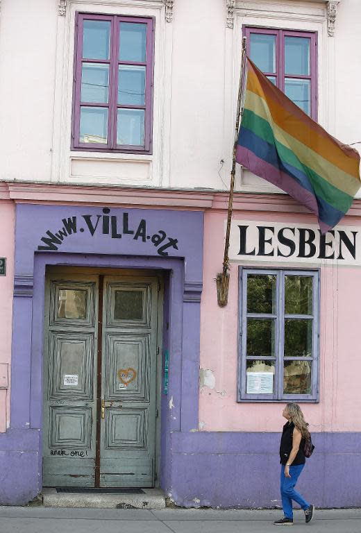 A woman passes by the 'Rosa-Lila Villa', a meeting point of the gay community in Vienna's Old Town, on May 2, 2014