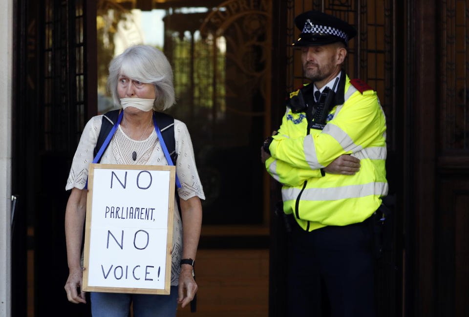 An Anti- Brexit demonstrator protests outside The Supreme Court in London, Tuesday, Sept. 17, 2019. The Supreme Court is set to decide whether Prime Minister Boris Johnson broke the law when he suspended Parliament on Sept. 9, sending lawmakers home until Oct. 14 — just over two weeks before the U.K. is due to leave the European Union.(AP Photo/Alastair Grant)