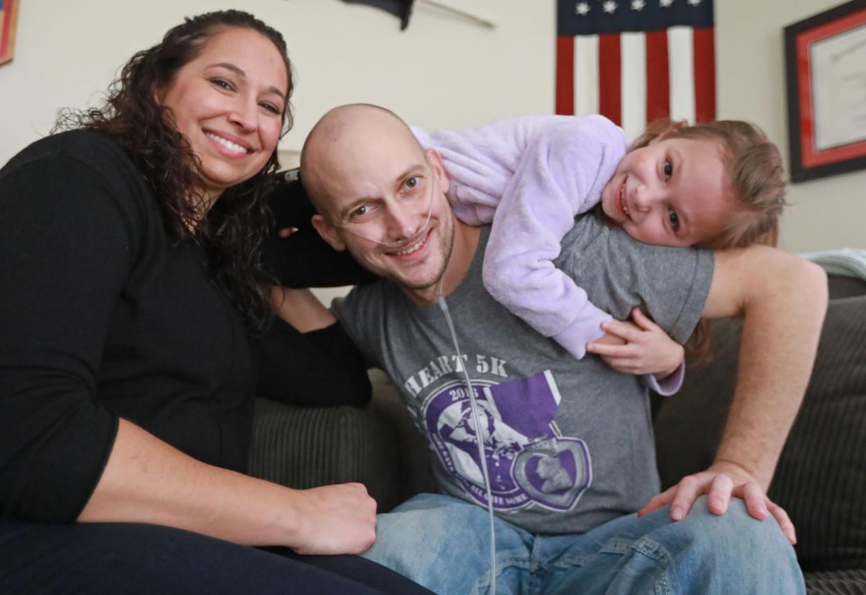 Danielle Robinson, left, is pictured with her husband Heath Robinson and daughter Brielle. Heath Robinson died in 2020 after a battle with cancer caused by exposure to toxic smoke from trash burning pits during his deployment to Iraq. Danielle will attend Tuesday's State of the Union Address.