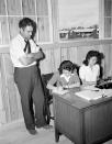 <p>Young Japanese women work in the office of the camp at Rohwer Relocation Center near McGehee, Arkansas, as stenographers and clerks, Sept. 21, 1942. Placement officer Mr. N.L. Abbot, left, dictates to Esther Ogasawara as her sister Reiko does some typing. (AP Photo/Horace Cort) </p>