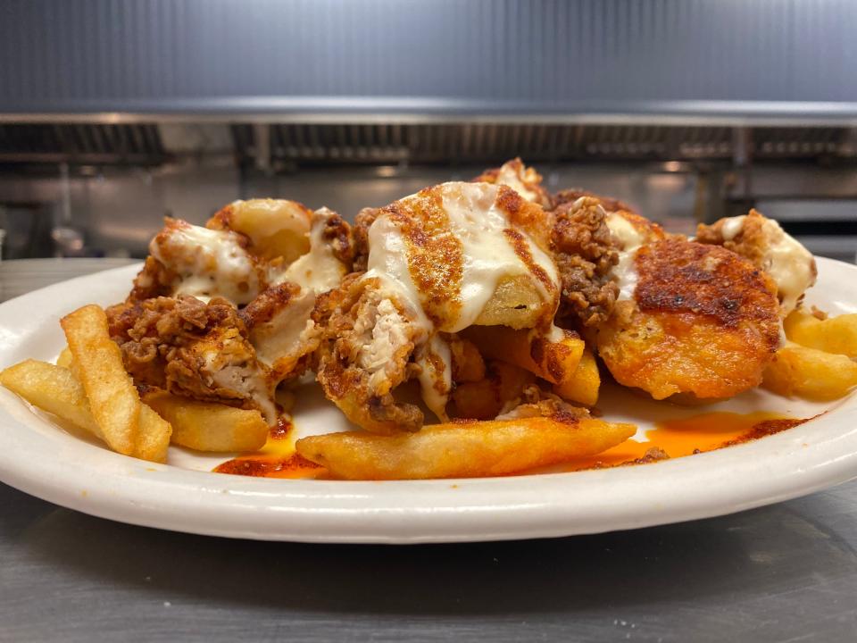 Dee Fries, loaded with chopped fried chicken tenders, fried pickles, Dean's Nashville hot sauce and a melted cheddar sauce will be on the menu at the new Dean's Chicken & Seafood expected to open in Plumstead this summer.