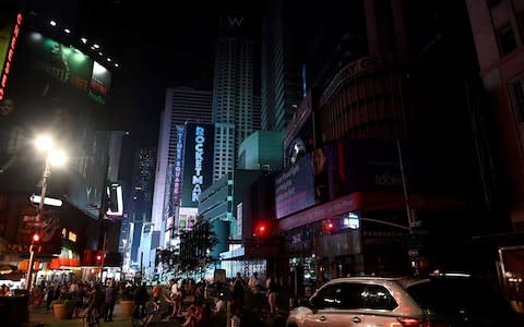 People walked down the street in Manhattan after the outage - Credit: AFP