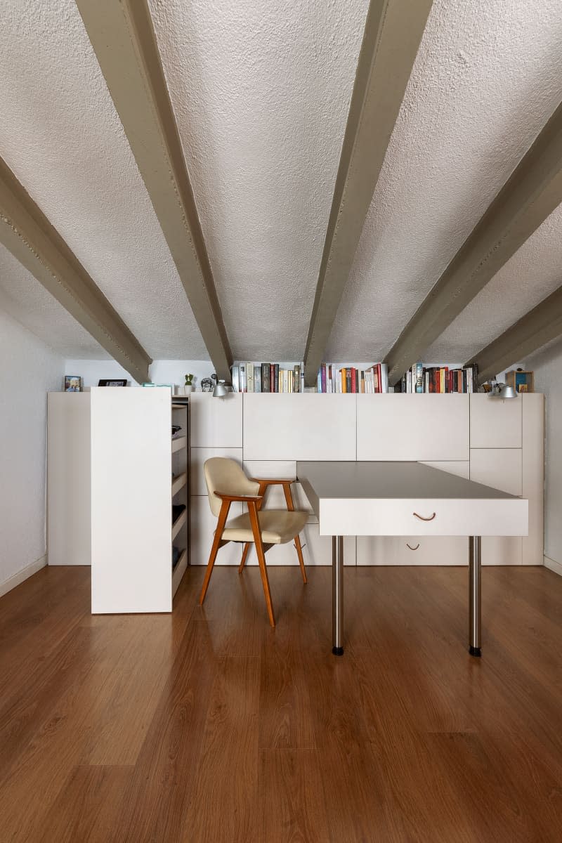 Pull-out modular shelving and desk in neutral toned room.