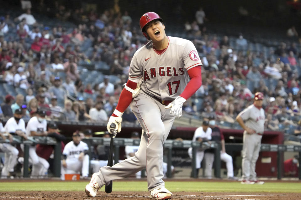 Los Angeles Angels' Shohei Ohtani reacts after fouling a pitch off his foot in the third inning during a baseball game against the Arizona Diamondbacks, Friday, June 11, 2021, in Phoenix. (AP Photo/Rick Scuteri)