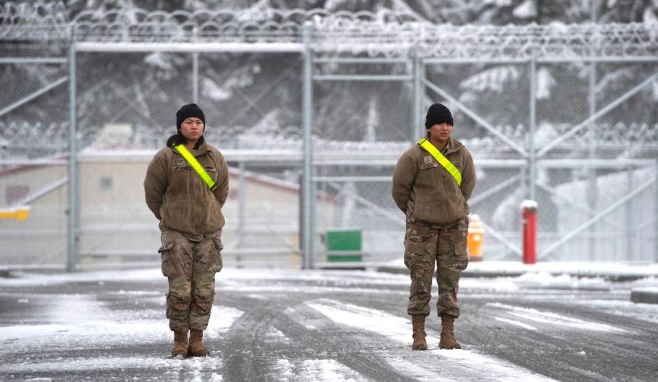 Pfc. Fate Garcia (left) of Sacramento, California, and Pfc. Yolanda Tomas of Ft. Meyers, Florida, stand security watch outside the new Northwest Joint Regional Correctional Facility at Joint Base Lewis-McChord, Washington, on Thursday, Dec. 1, 2022.