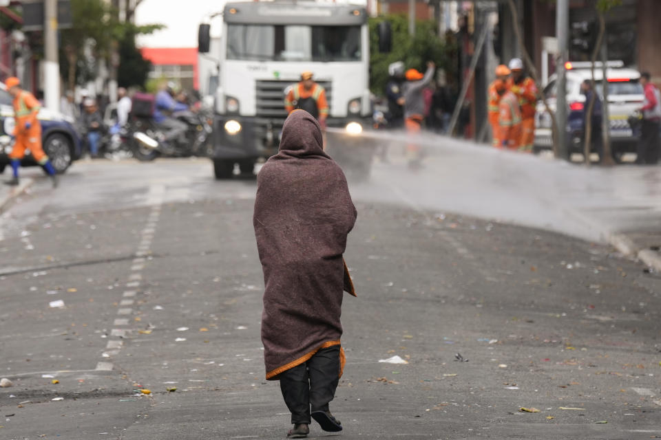 A drug user walks on a street in Santa Efigenia shopping district, a major commercial hub for electronics, technology products, and accessories in downtown Sao Paulo, Brazil, Thursday, May 18, 2023. (AP Photo/Andre Penner)