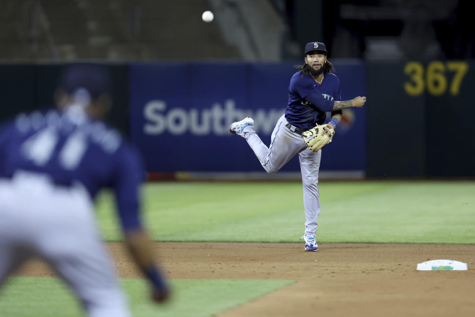 Seattle Mariners shortstop J.P. Crawford throws out Oakland Athletics' Conner Capel during the third inning of a baseball game in Oakland, Calif., Tuesday, Sept. 20, 2022. (AP Photo/Jed Jacobsohn)