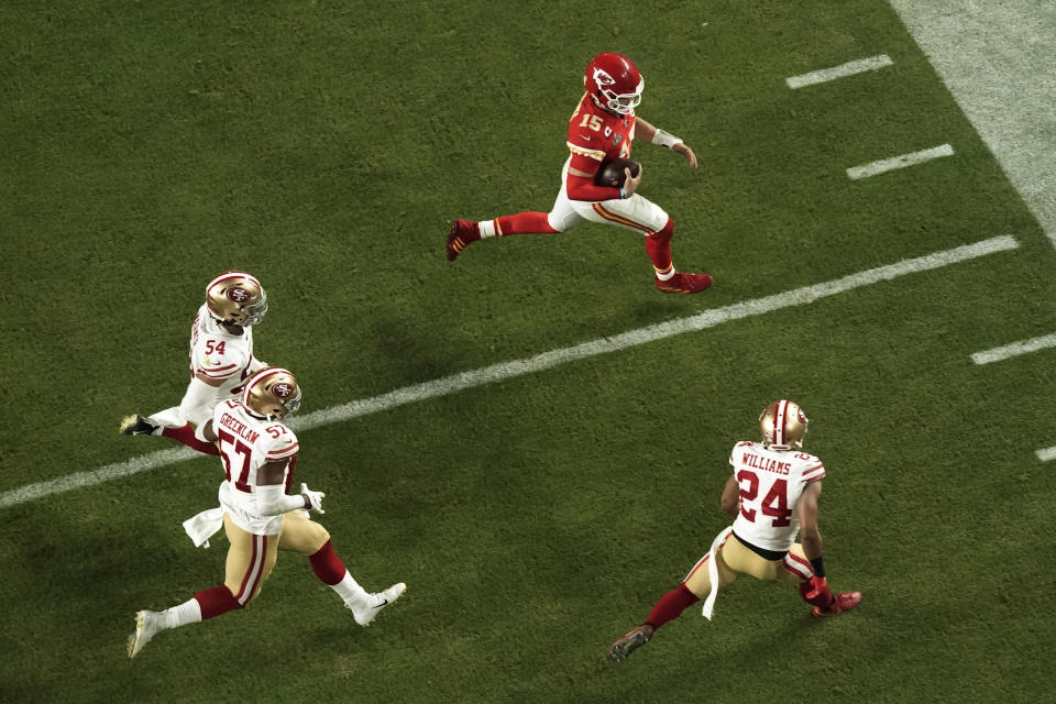 Kansas City Chiefs quarterback Patrick Mahomes (15) is pursued by San Francisco 49ers' K'Waun Williams (24), Dre Greenlaw (57), and Fred Warn (54), during the second half of the NFL Super Bowl 54 football game Sunday, Feb. 2, 2020, in Miami Gardens, Fla. (AP Photo/Morry Gash)