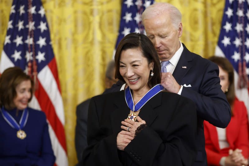 U.S. President Joe Biden presents actress Michelle Yeoh with the Presidential Medal of Freedom, the country's highest civilian honor, during a ceremony in the East Room of the White House in Washington on Friday. Photo by Jonathan Ernst/UPI