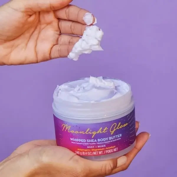 Shea body butter being held by a model