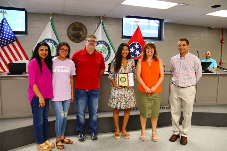 Pictured from left, Rosanna and Brianna Castillo, School Board Chairman Michael Fulbright, Sydney Castillo, Maury County Schools Superintendent, Lisa Ventura and Donald Castillo. The Castillo family is honored with an award plaque for perfect attendance during Sydney's entire K-12 schooling.