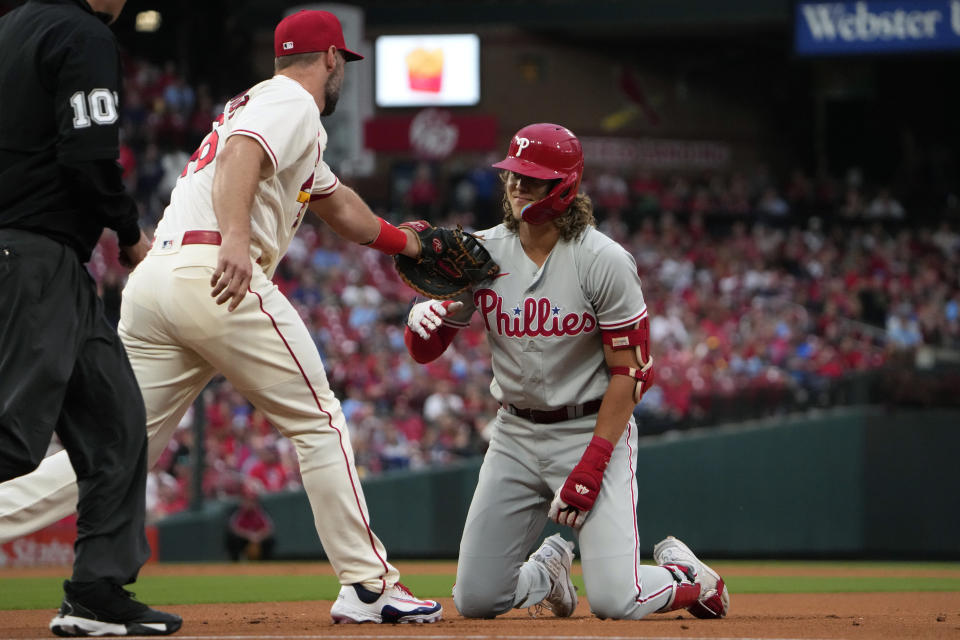 Philadelphia Phillies' Alec Bohm, right, is tagged out by St. Louis Cardinals first baseman Paul Goldschmidt after falling while rounding first on an RBI single during the first inning of a baseball game Saturday, Sept. 16, 2023, in St. Louis. (AP Photo/Jeff Roberson)