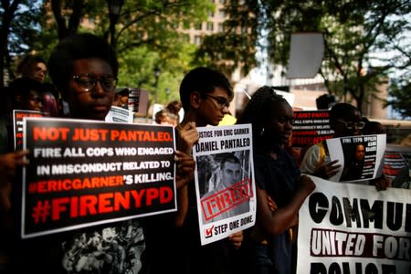 People wait for the arrival of Gwen Carr, mother of Eric Garner for a press conference outside Police Headquarters in New York