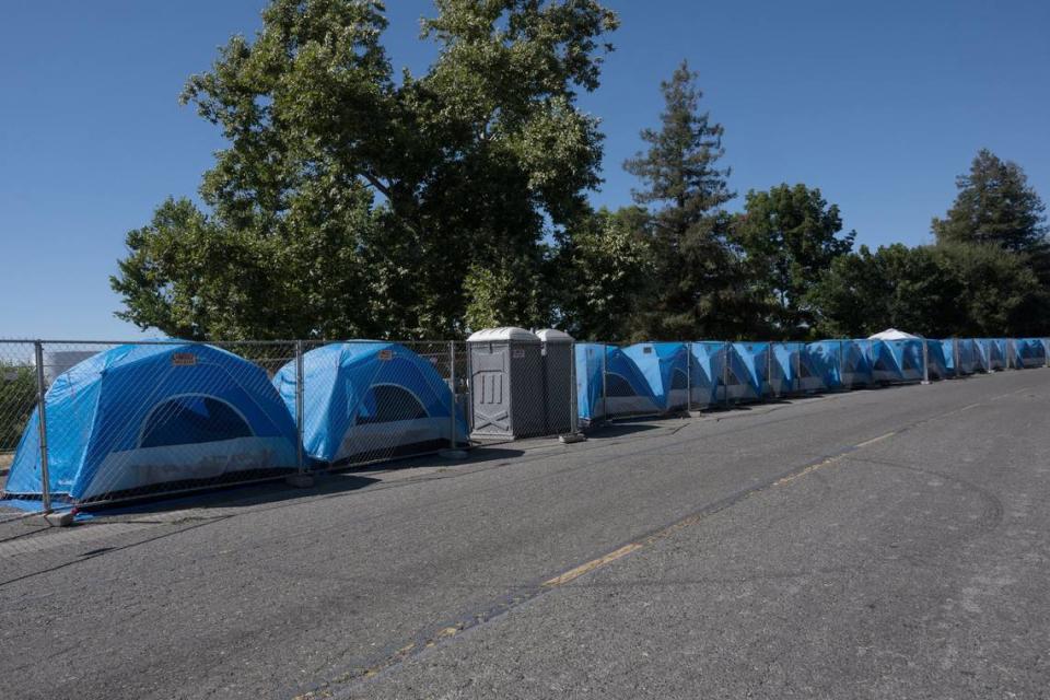 Tents bake in the afternoon sun as temperatures hit 91  degrees – cooler than many recent days – at the Safe Ground at Miller Park in Sacramento in August. Communities in partnership with the City of Sacramento. Homeless advocates say there is no protection from the extreme heat at the site because most of the tents are on hot asphalt in direct sunlight.