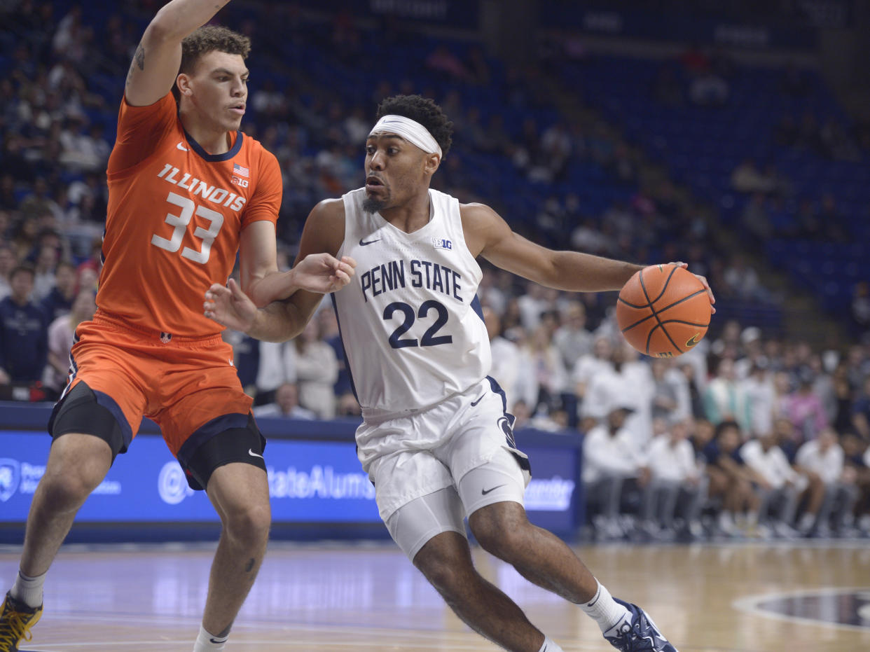 Penn State's Jalen Pickett (22) drives the basket on Illinois' Coleman Hawkins (33) during the first half of an NCAA college basketball game, Tuesday, Feb. 14, 2023, in State College, Pa. (AP Photo/Gary M. Baranec)
