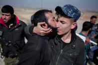 <p>A civilian kisses a federal police officer after escaping Islamic State territory in the town of Abu Saif, Tuesday, Feb. 21, 2017. Iraqi forces advanced into the southern outskirts of Mosul in a push to drive Islamic State militants from the city’s western half, as the visiting U.S. defense secretary met with officials to discuss the fight against the extremists. (AP Photo/Bram Janssen) </p>