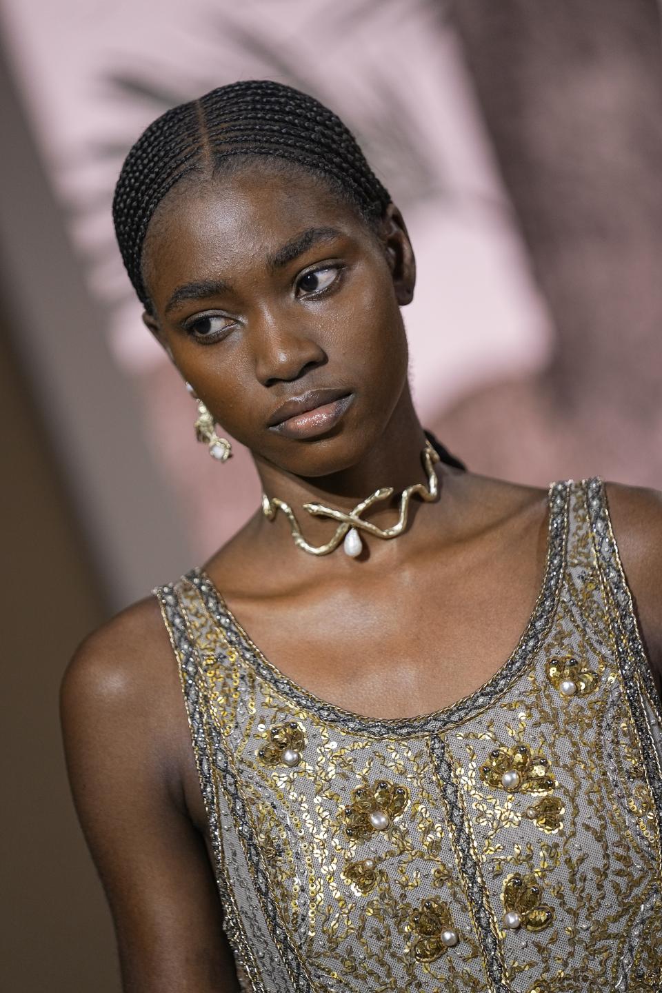 A model wears a creation for the Christian Dior Haute Couture Fall/Winter 2023-2024 fashion collection presented in Paris, Monday, July 3, 2023. (AP Photo/Michel Euler)