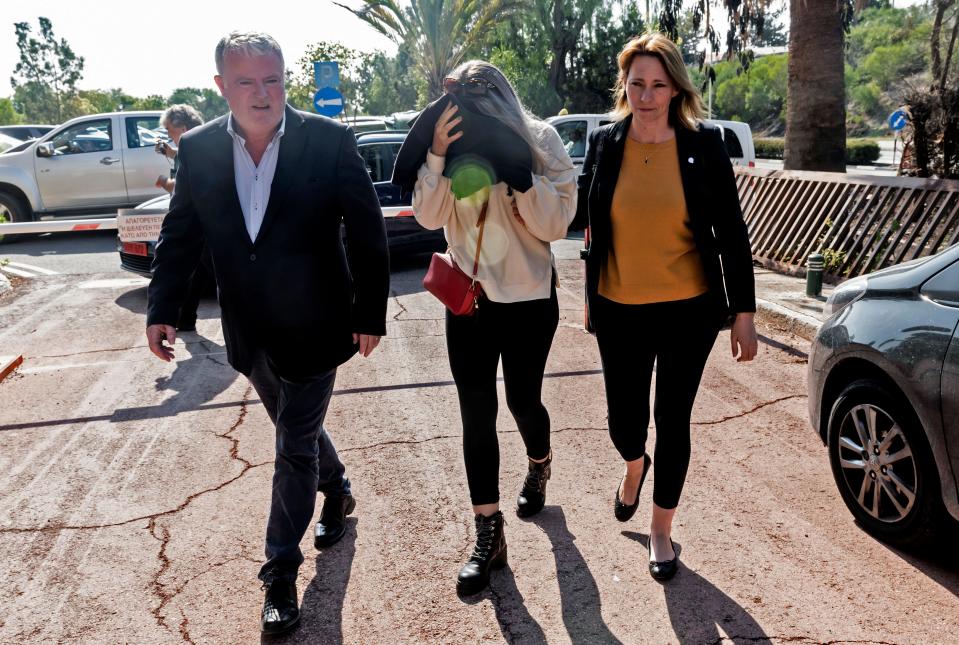 A British teenager who accused seven Israelis of gang rape covers her face as she comes in the Larnaca District Court on November 01, 2019. - Initially, the Briton had alleged 12 Israelis raped her on July 17 at a hotel in the resort of Ayia Napa, a magnet for younger tourists attracted by its beaches and nightlife. The Israelis aged 15 to 18, several of whom had been detained, were released without charge after she was arrested on suspicion of "making a false statement about an imaginary crime", according to police. (Photo by Iakovos Hatzistavrou / AFP) (Photo by IAKOVOS HATZISTAVROU/AFP via Getty Images)