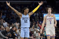 Memphis Grizzlies guard Ja Morant (12) celebrates next to Oklahoma City Thunder guard Josh Giddey (3) during the second half of an NBA basketball game Wednesday, Dec. 7, 2022, in Memphis, Tenn. (AP Photo/Brandon Dill)