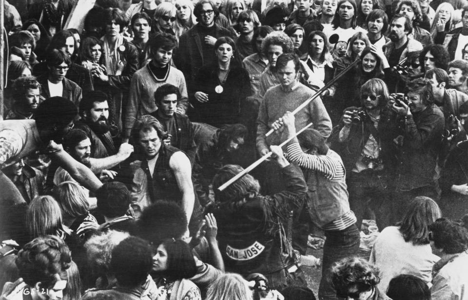 A still from the documentary film 'Gimme Shelter,' showing audience members looking on as Hells Angels beat a fan with pool cues at the Altamont Free Concert, Altamont Speedway, California, Dec. 6, 1969. (Photo: Bill Owens/20th Century Fox/Hulton Archive/Getty Images)