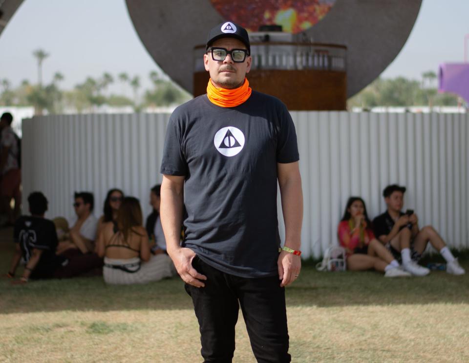 Palm Springs artist Cristopher Cichocki stands before his Coachella Valley Arts and Music Festival art installation "Circular Dimensions x Microscape" in Indio, Calif., on April 16, 2022.