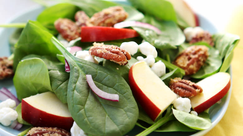 Apple slices on spinach salad