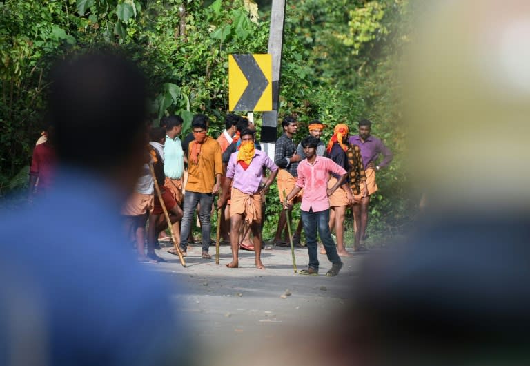 Stone-throwing Hindu activists faced off against police near a Kerala temple that a court has ordered open to women