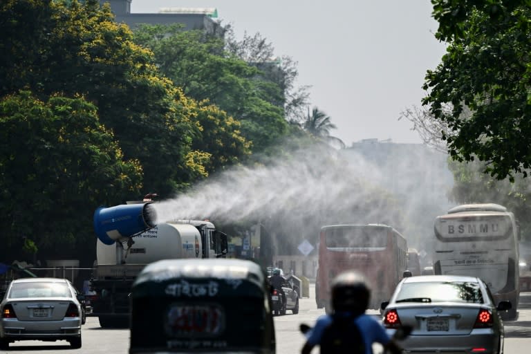 A vehicle of the Dhaka North City Corporation sprays water along a busy road to lower the temperature amidst a heatwave (MUNIR UZ ZAMAN)
