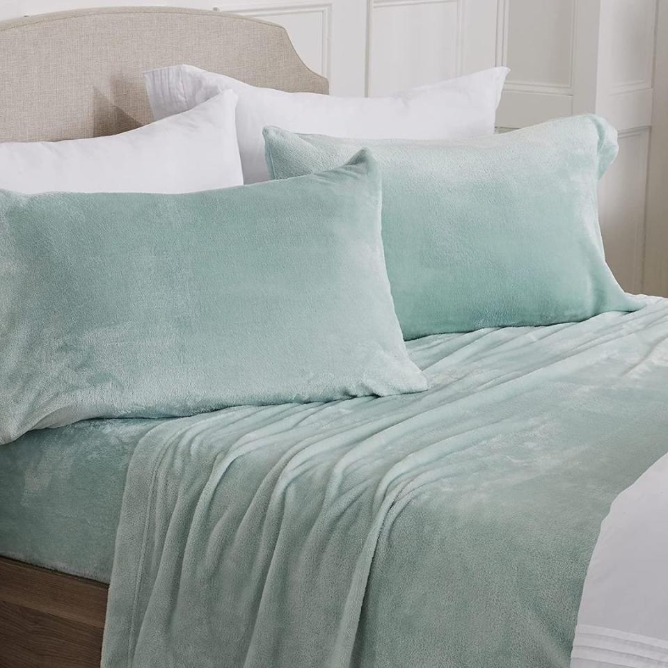 If you ever wished your favorite snuggly throw blanket could cover your whole bed, you're in luck. This set is giving all the cozy vibes and includes a fitted sheet, flat sheet and two pillowcases. It comes in 28 colors in sizes from twin to king.Promising review: 