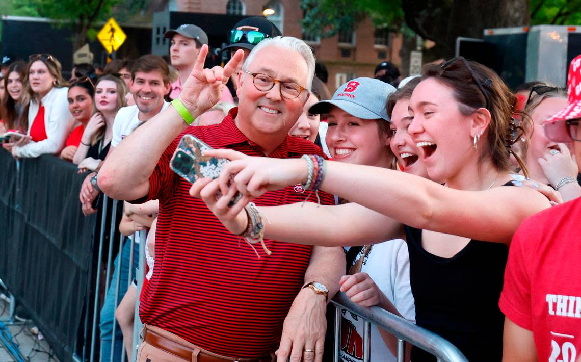 N.C. State Chancellor Randy Woodson poses with students during a celebration for the N.C. State men’s and women’s basketball team at the Memorial Belltower in Raleigh, N.C., Monday, April 15, 2024. Both teams made it to the NCAA Tournament Final Four and the men’s team won the ACC Championship by winning five games in five days.